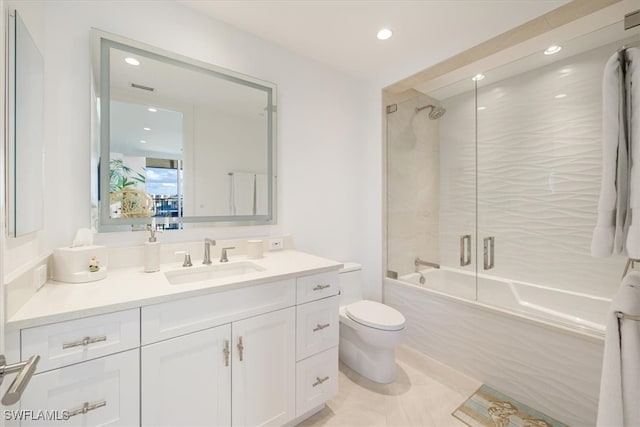 full bathroom featuring shower / bath combination with glass door, tile patterned floors, vanity, and toilet