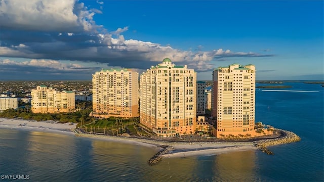 drone / aerial view featuring a beach view and a water view