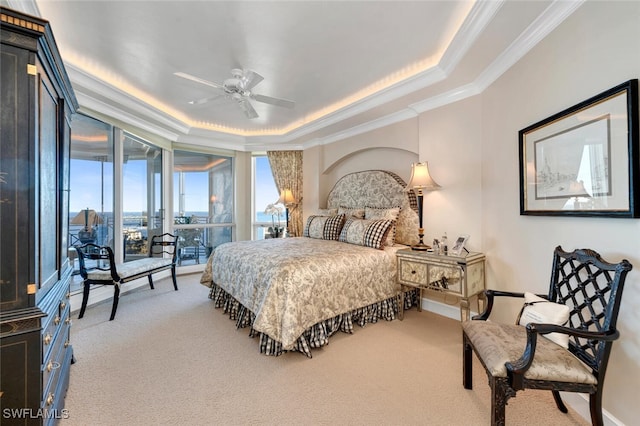 bedroom featuring carpet flooring, ceiling fan, a raised ceiling, and crown molding