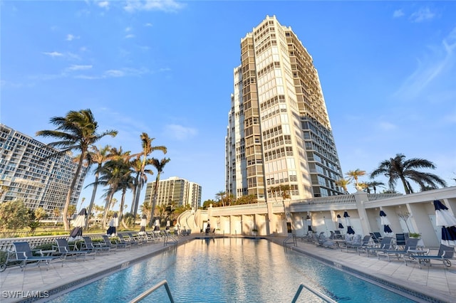 view of swimming pool featuring a patio area and a water view