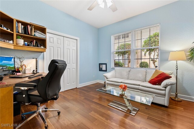 home office with hardwood / wood-style floors and ceiling fan