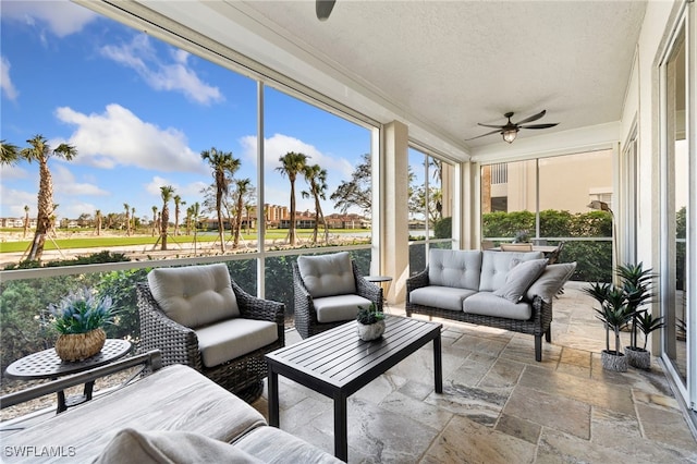 sunroom featuring ceiling fan