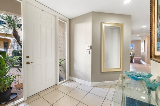 entryway with light tile patterned floors, recessed lighting, and baseboards