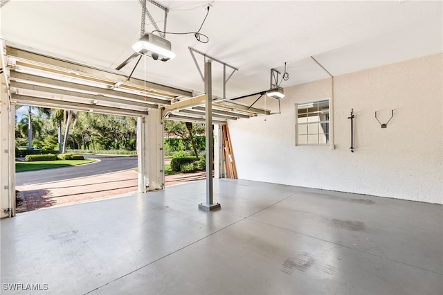 garage with a garage door opener and a textured wall