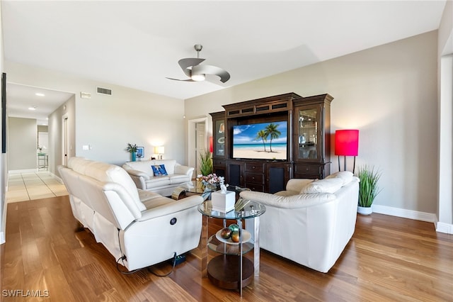 living room with hardwood / wood-style flooring and ceiling fan