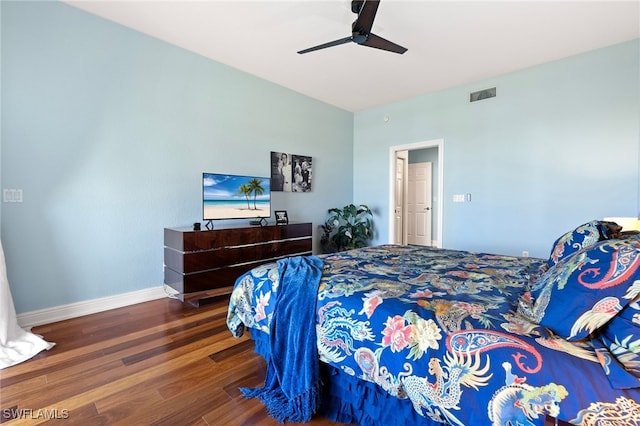 bedroom featuring ceiling fan, visible vents, baseboards, and wood finished floors