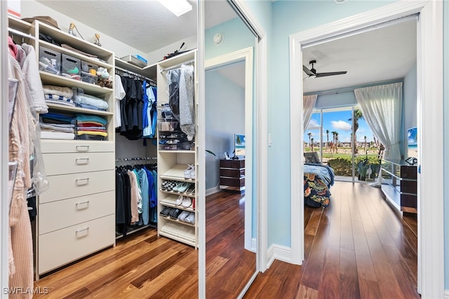 walk in closet with ceiling fan and wood finished floors