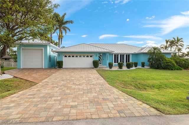 ranch-style home with a garage and a front lawn