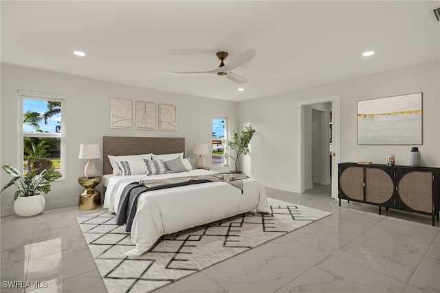 bedroom featuring recessed lighting, multiple windows, and marble finish floor