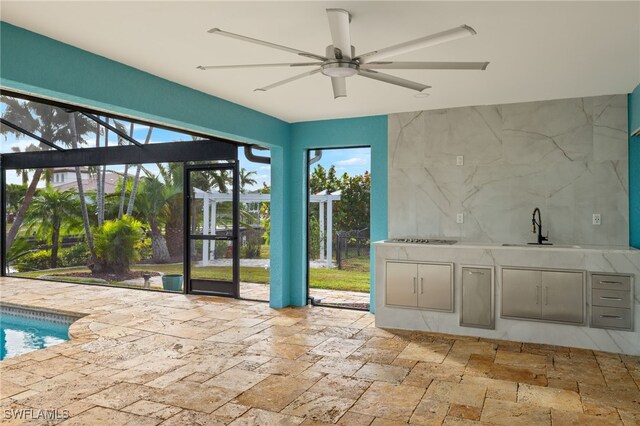 interior space featuring ceiling fan and sink