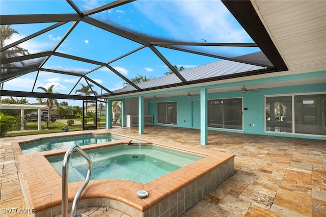 view of pool with an in ground hot tub, a lanai, ceiling fan, and a patio