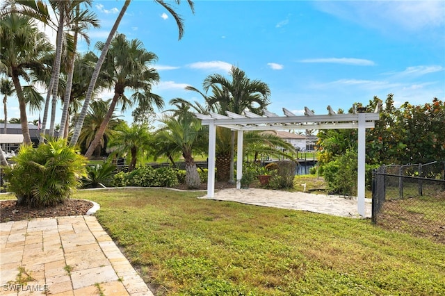 view of yard featuring fence and a pergola