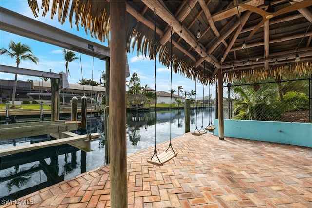 dock area with boat lift and a water view