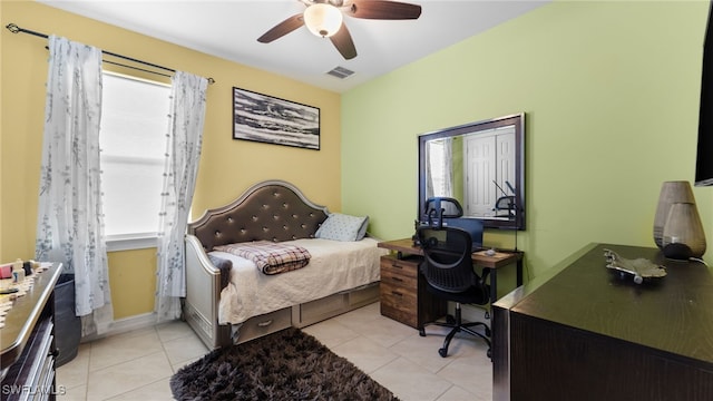 tiled bedroom featuring ceiling fan