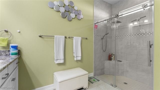 bathroom featuring an enclosed shower, vanity, and tile patterned floors