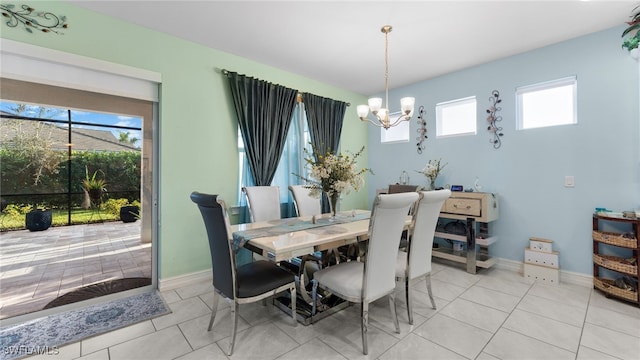 dining space with light tile patterned flooring and an inviting chandelier