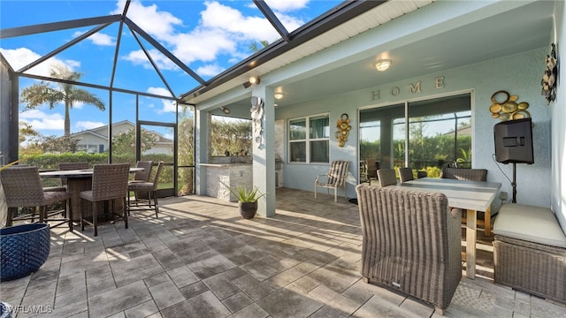 view of patio with exterior bar and glass enclosure