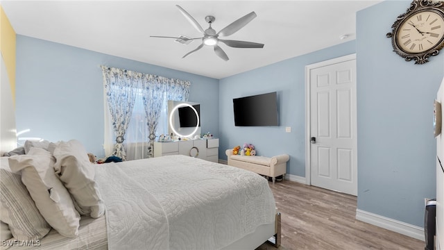 bedroom with ceiling fan and light hardwood / wood-style floors