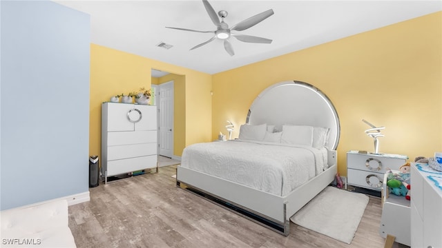 bedroom with ceiling fan and light hardwood / wood-style flooring