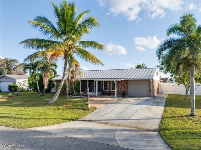 view of front of home featuring a garage and a front yard