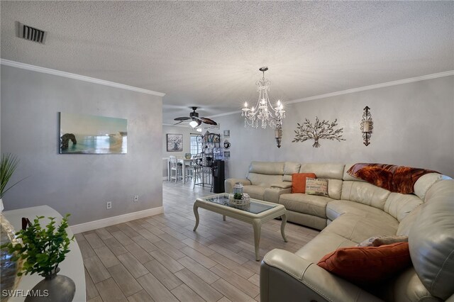 living room with ornamental molding, ceiling fan with notable chandelier, and light wood-type flooring