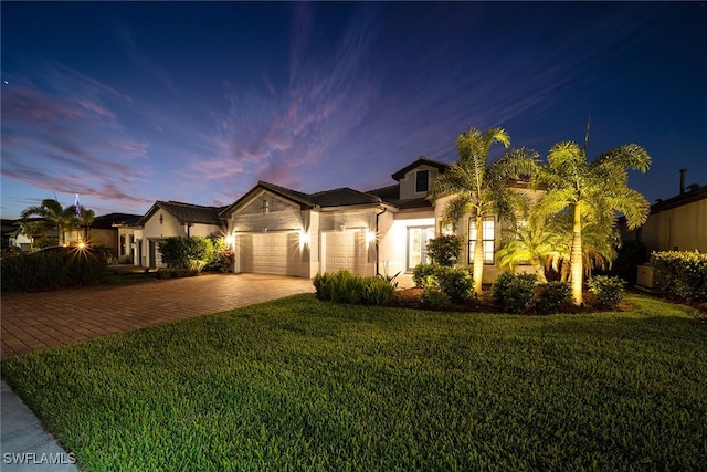 view of front of house with a lawn and a garage