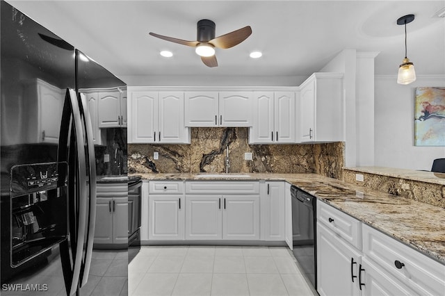 kitchen featuring backsplash, light stone counters, sink, black appliances, and white cabinetry