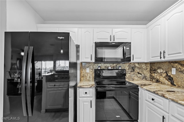 kitchen featuring black appliances, tile patterned floors, decorative backsplash, light stone countertops, and white cabinetry