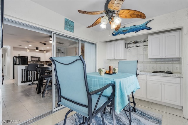 dining room featuring ceiling fan and light tile patterned floors