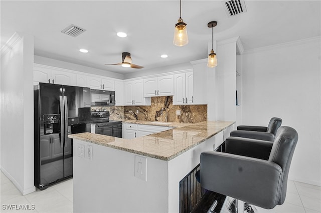 kitchen with black appliances, kitchen peninsula, decorative light fixtures, a kitchen bar, and white cabinetry