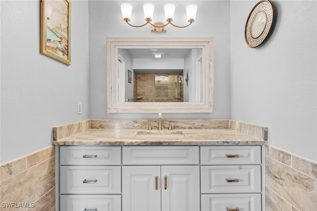 bathroom featuring vanity and tile walls