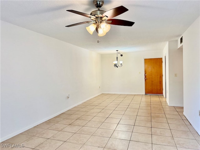 tiled spare room featuring a textured ceiling and ceiling fan