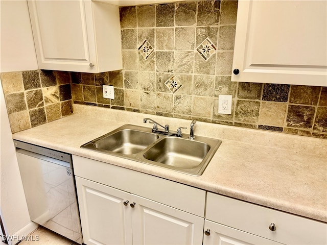 kitchen featuring backsplash, white cabinetry, sink, and stainless steel dishwasher