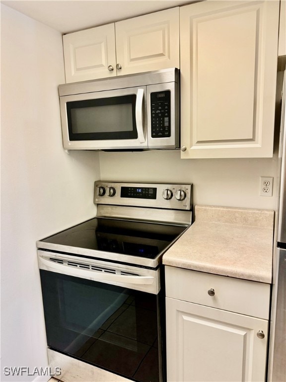 kitchen with white cabinetry and stainless steel appliances