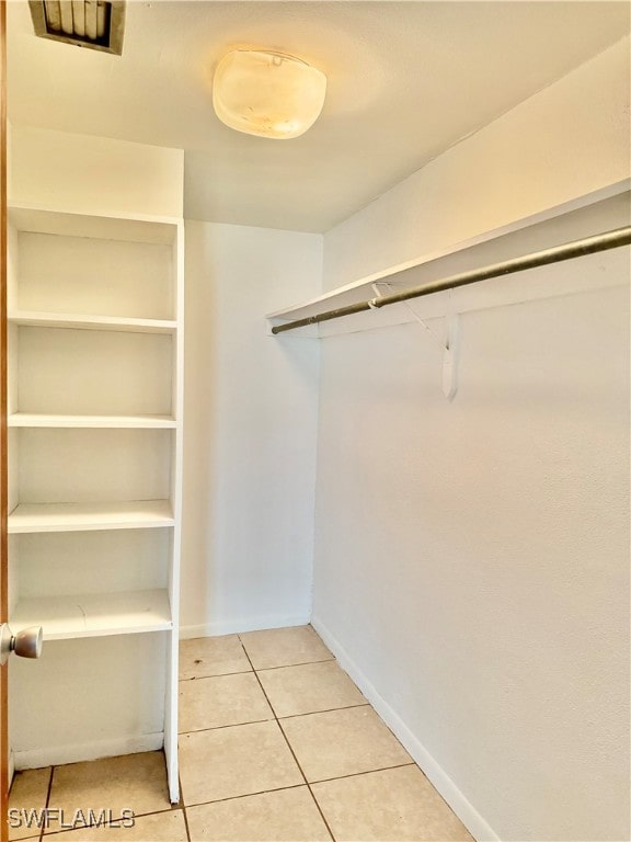 spacious closet with light tile patterned flooring