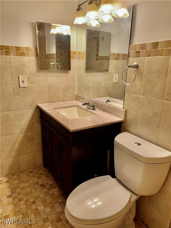 bathroom featuring vanity and tile walls