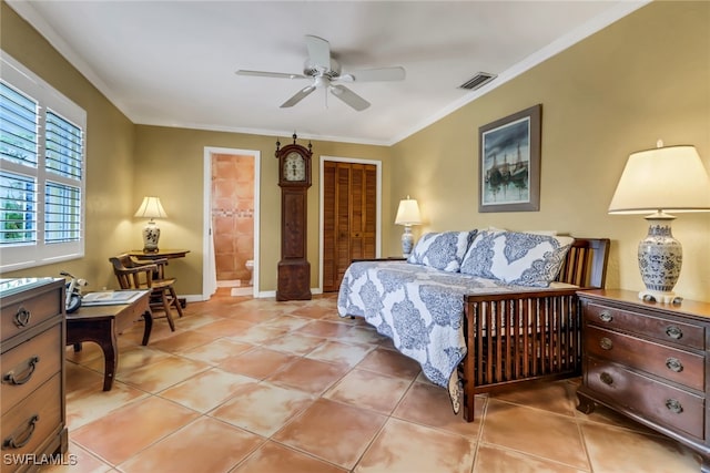 tiled bedroom featuring a closet, ensuite bathroom, ceiling fan, and ornamental molding