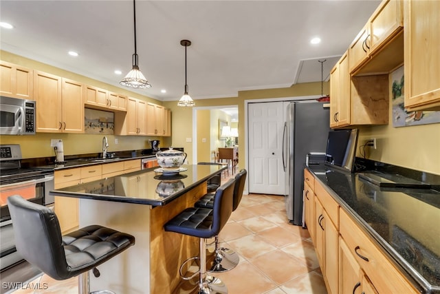 kitchen featuring appliances with stainless steel finishes, light brown cabinetry, a kitchen breakfast bar, sink, and light tile patterned flooring