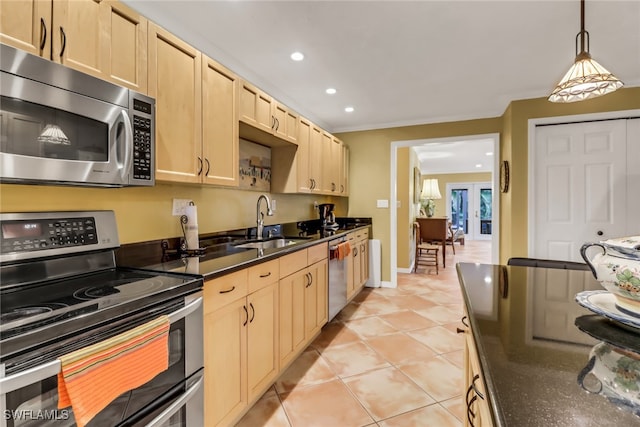 kitchen featuring stainless steel appliances, sink, light brown cabinets, decorative light fixtures, and light tile patterned flooring