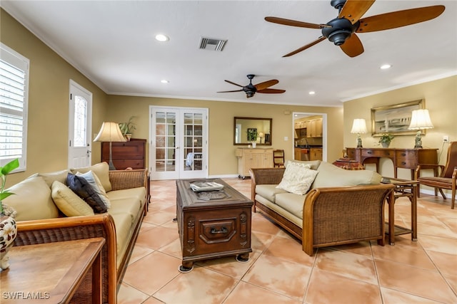 tiled living room featuring ceiling fan, french doors, and ornamental molding