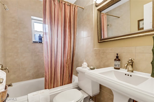 full bathroom with sink, toilet, decorative backsplash, shower / tub combo with curtain, and tile walls