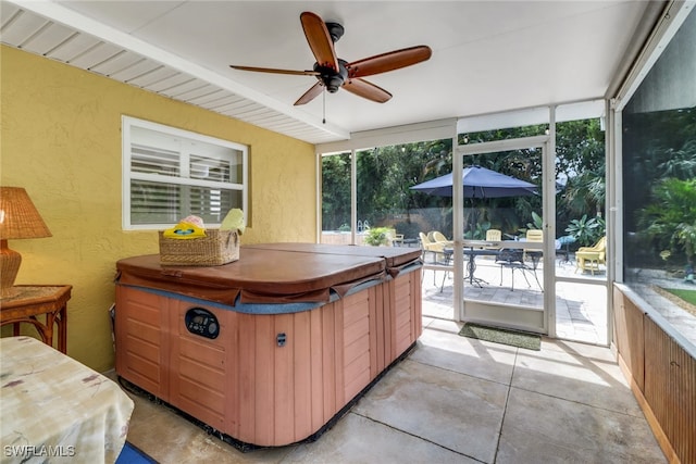 sunroom featuring beam ceiling, a hot tub, and ceiling fan