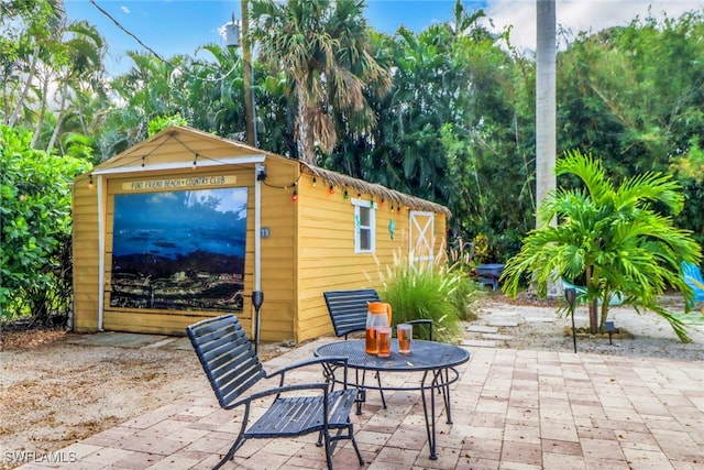 view of patio / terrace featuring an outbuilding