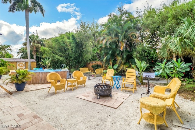 view of patio with a shed and an outdoor fire pit