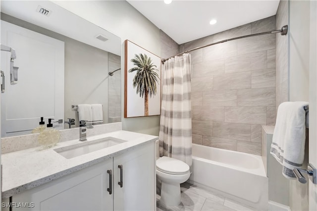 full bathroom featuring vanity, shower / bath combo, and toilet