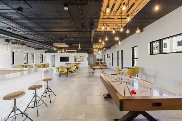 rec room with a wealth of natural light and light tile patterned floors