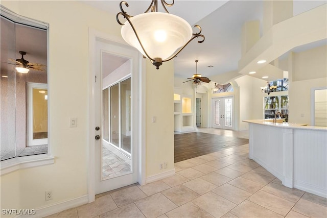 kitchen with pendant lighting, light tile patterned floors, french doors, and ceiling fan