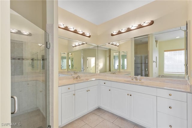 bathroom featuring vanity, tile patterned floors, and a shower with shower door