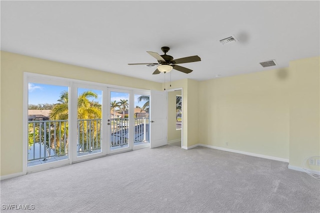 carpeted spare room with ceiling fan