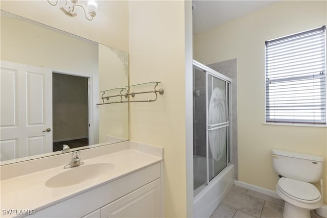 full bathroom with vanity, tile patterned flooring, bath / shower combo with glass door, and toilet